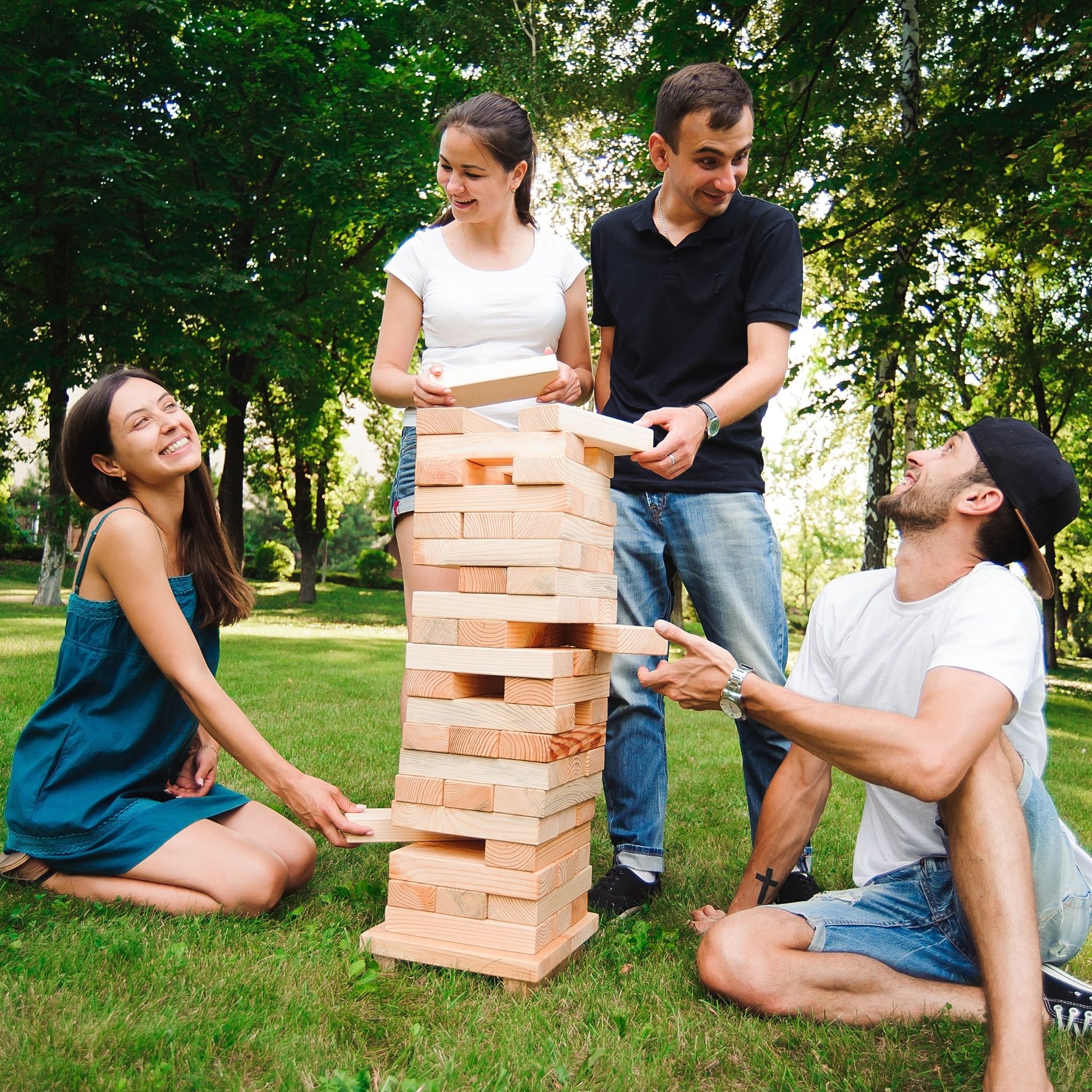 Lifesize wooden tumbling towers party rental game played at park in Louisville Kentucky